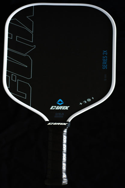 Pickleball paddle with 'Evolva' branding on a black background